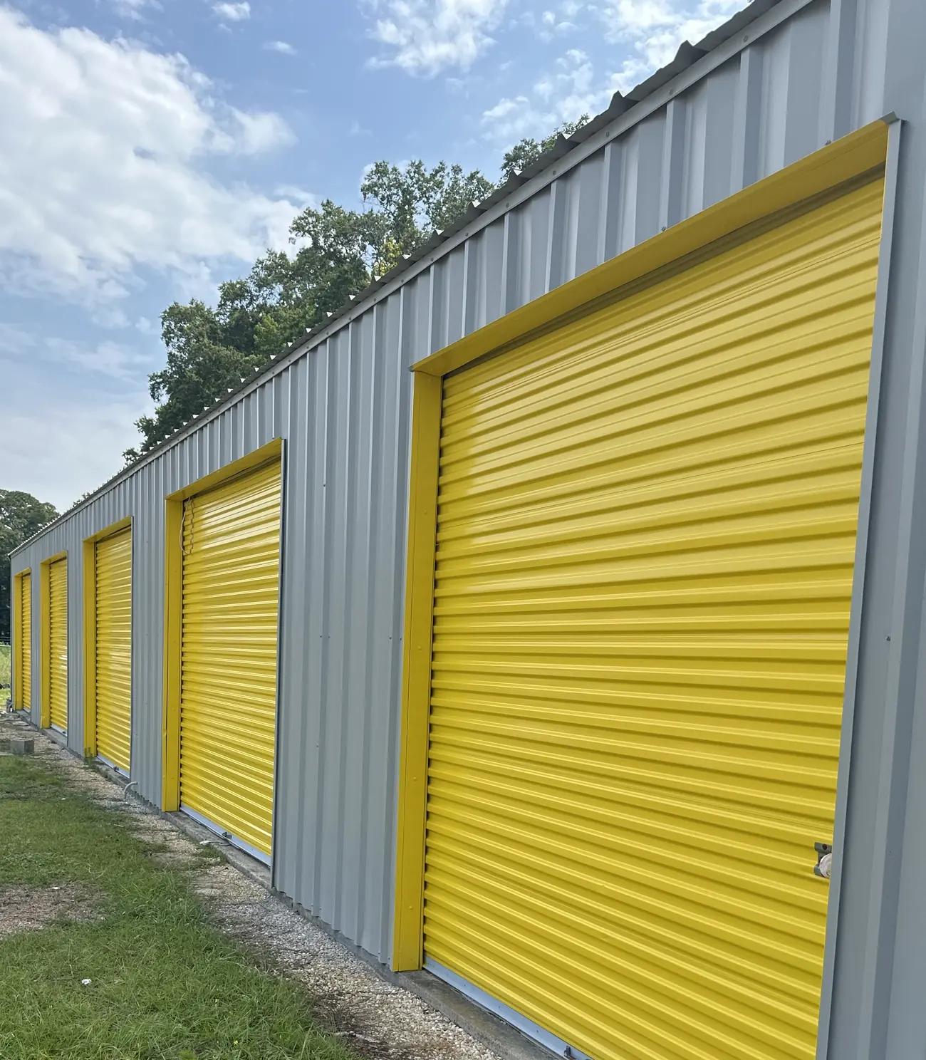 Yellow roll-up doors on ground-floor drive-up units at Self Storage Goldsboro