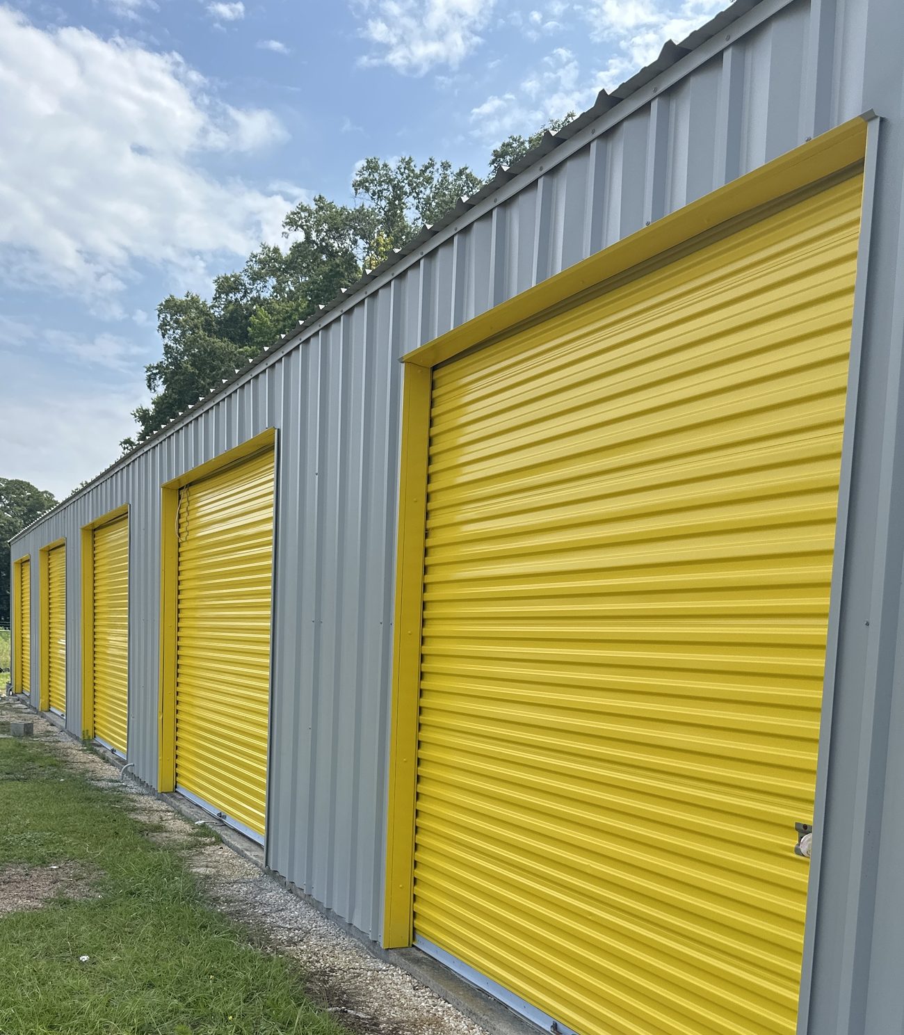 Yellow roll-up doors on ground-floor drive-up units at Self Storage Goldsboro