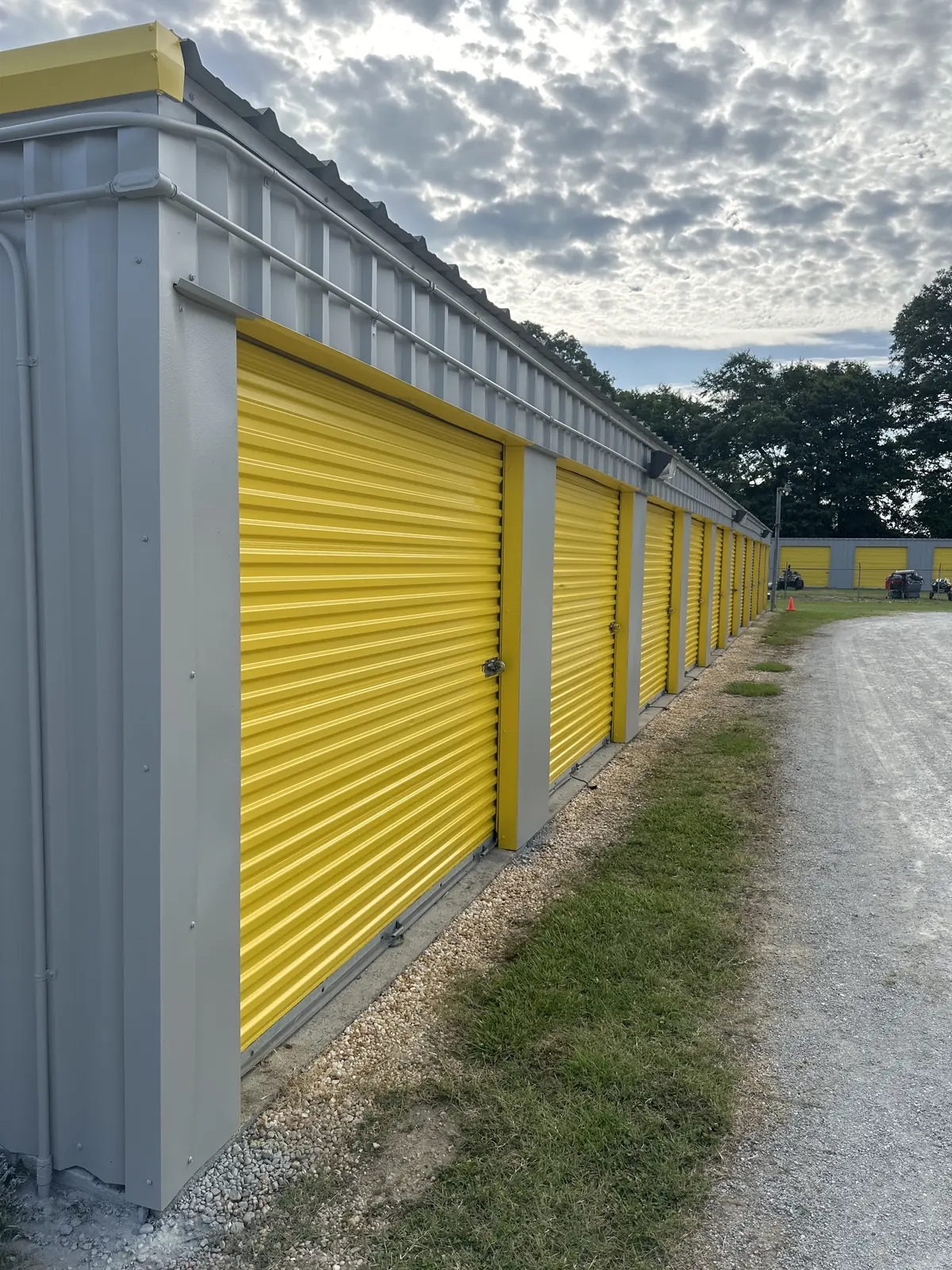 Ground-floor drive-up units with yellow roll-up doors at Self Storage Goldsboro