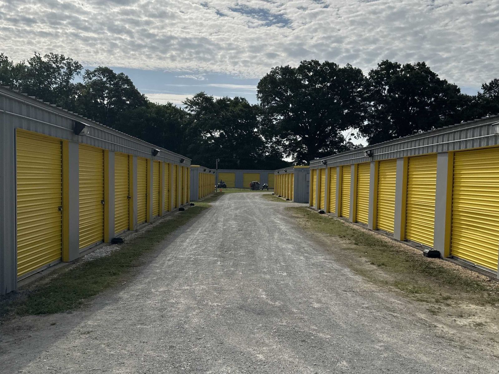 Rows of ground-floor drive-up units with yellow roll-up doors at Self Storage Goldsboro