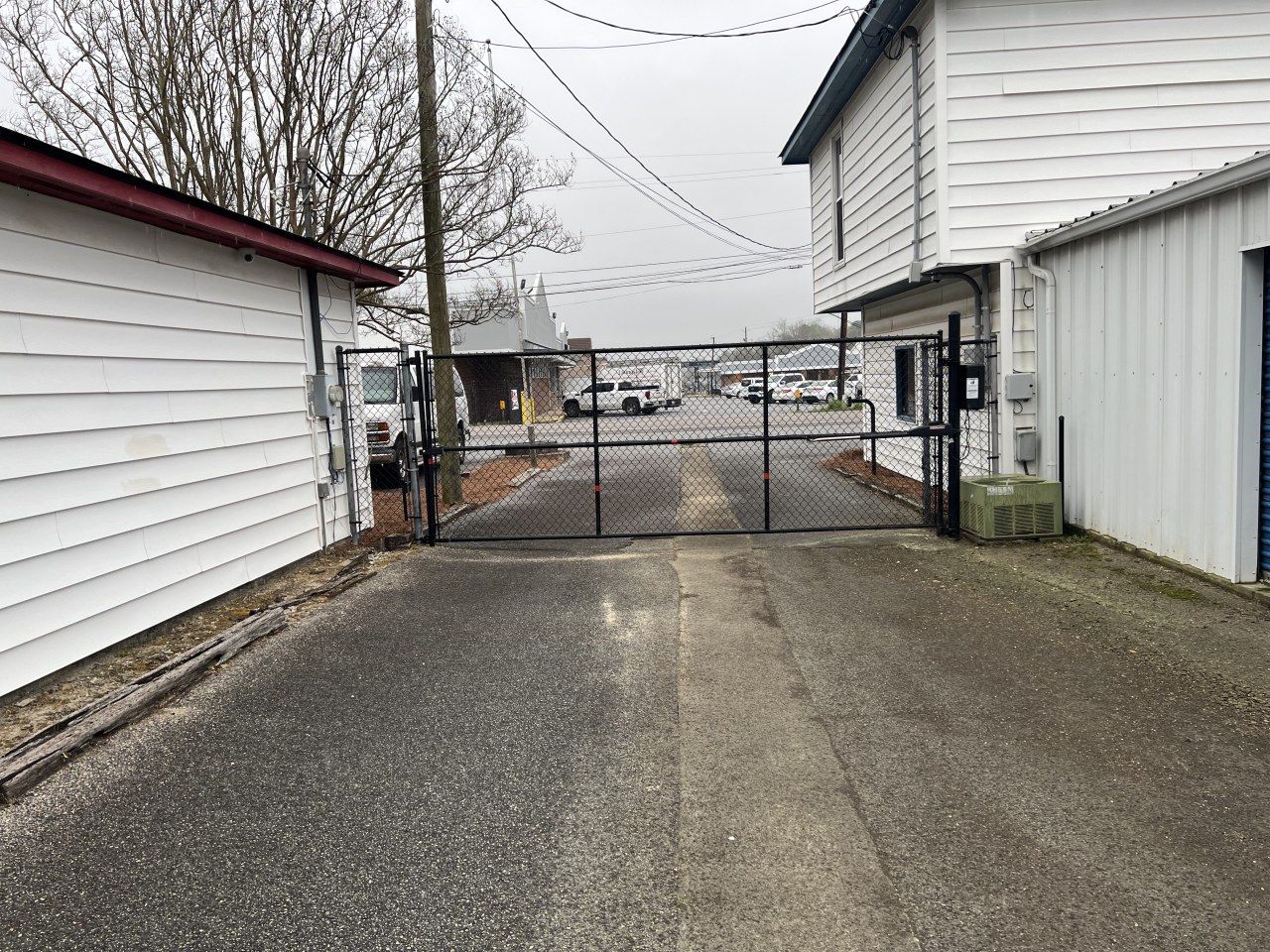 Professional RV storage facility showing covered and uncovered parking spaces with security fencing